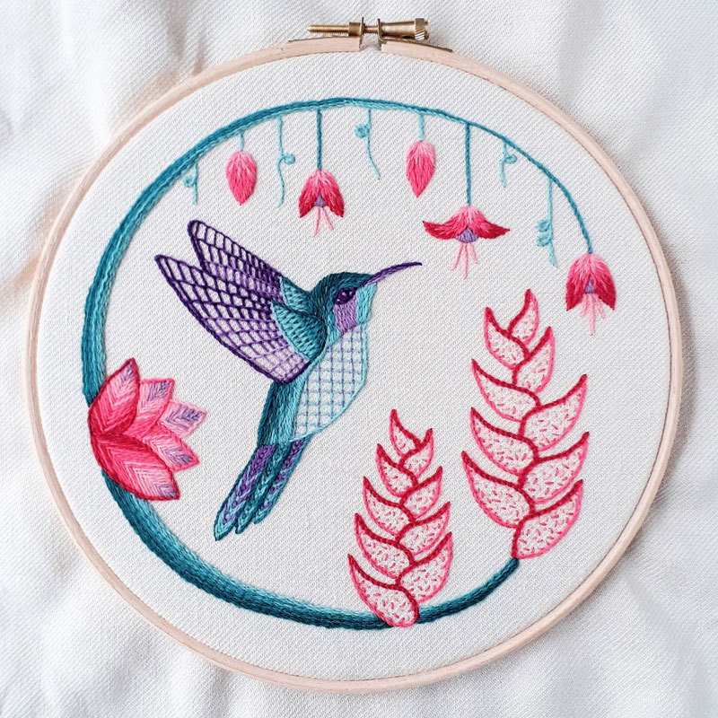 a blue hummingbird with pink flowers on a loop